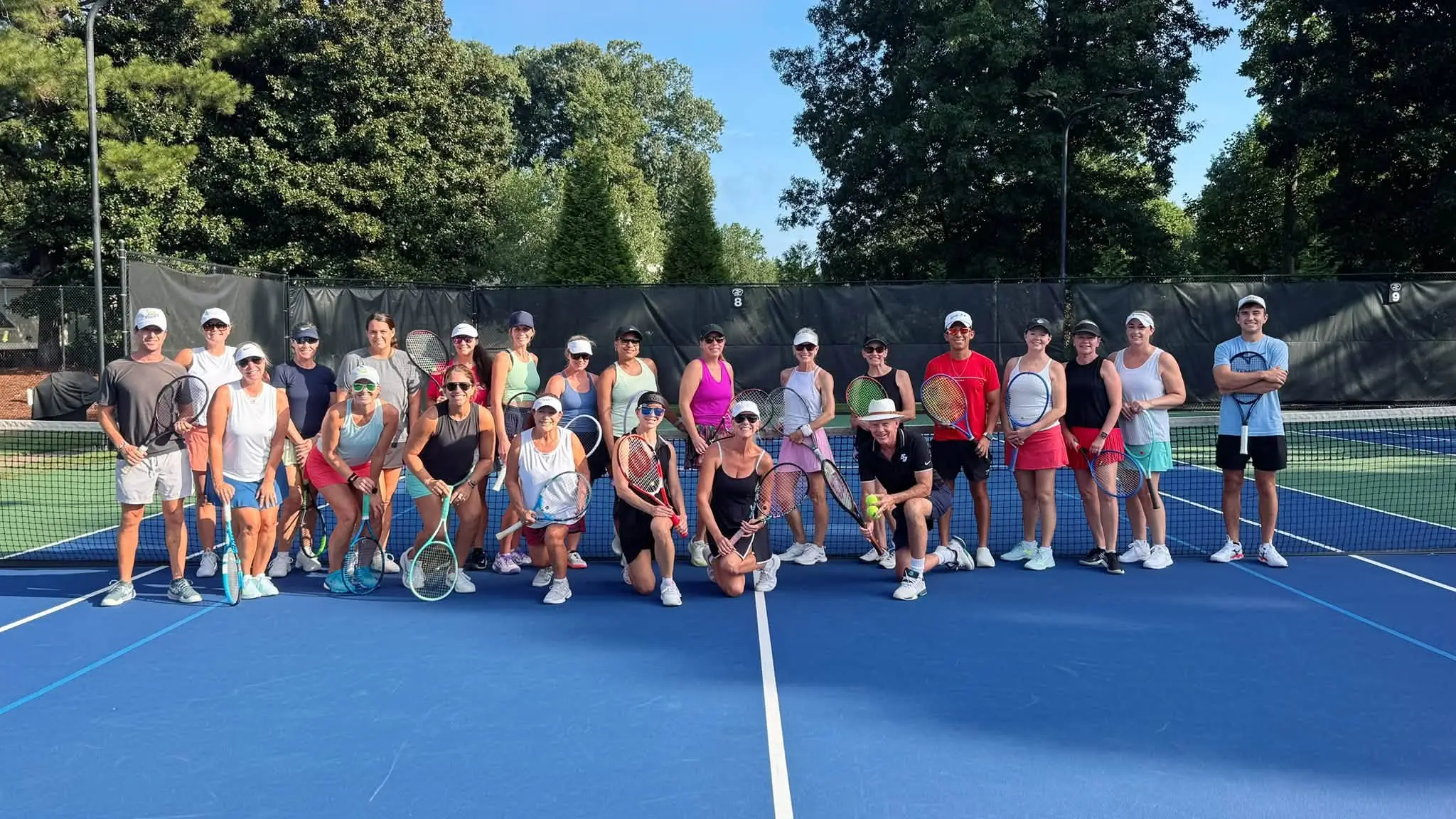 Adult players and coaches on court at Crooked Creek