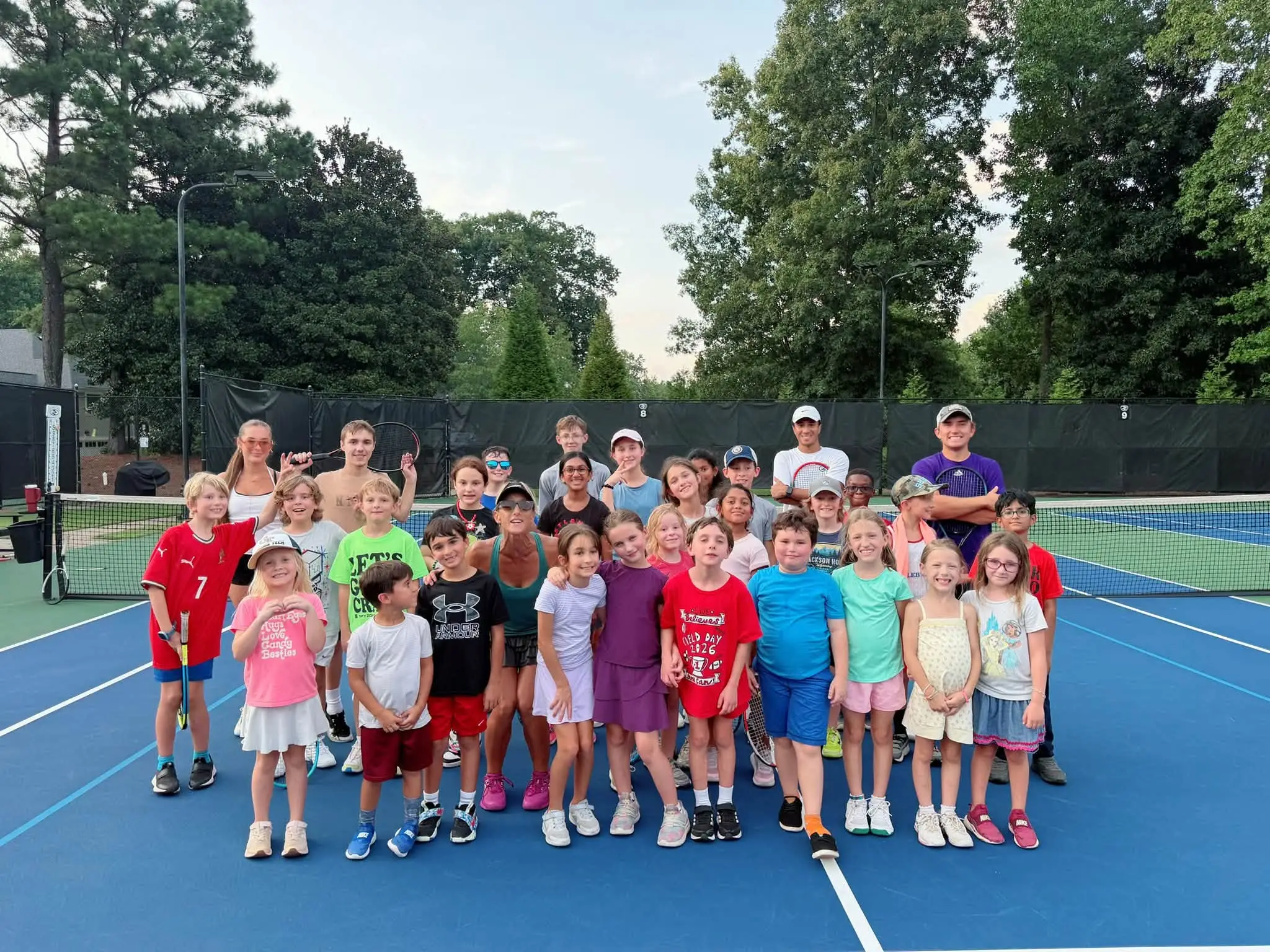A junior clinic group on court at Crooked Creek