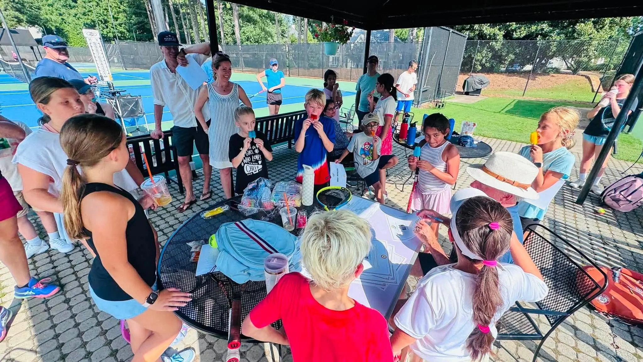 Juniors gathered under the tent beside the courts at Crooked Creek